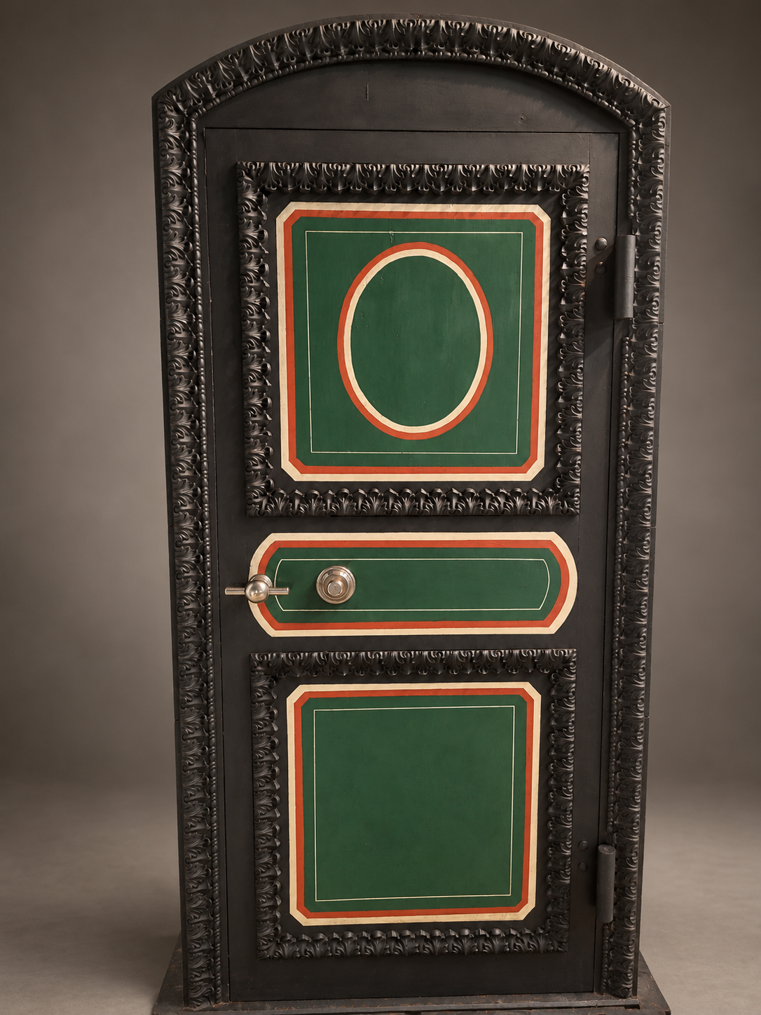 Restored Hall's vault entrance with an arched foliate surround, painted decorative panels, dial and handle.